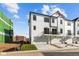 Rear exterior of white townhomes featuring garages and balconies, showcasing a modern design at 4191 Barrel Ln, Westfield, IN 46062