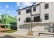 Back exterior of townhomes featuring white siding, garages and balconies in a new development at 4191 Barrel Ln, Westfield, IN 46062