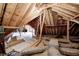 Unfinished attic with exposed rafters, insulation, and ventilation pipes at 6502 Allisonville Rd, Indianapolis, IN 46220