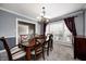 Traditional dining room featuring a chandelier and large windows at 6502 Allisonville Rd, Indianapolis, IN 46220