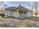 Cozy single story home with a covered porch, stone exterior, and a well-maintained yard at 6502 Allisonville Rd, Indianapolis, IN 46220