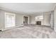 Bright living room featuring plush carpet and a fireplace at 6502 Allisonville Rd, Indianapolis, IN 46220