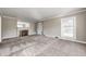 Light-filled living room featuring a fireplace and plush carpet at 6502 Allisonville Rd, Indianapolis, IN 46220