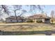Large brick home with a sprawling backyard and mature trees at 6502 Allisonville Rd, Indianapolis, IN 46220