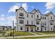 Charming new construction townhome with crisp white siding, black trim, covered entry, and well-manicured lawn at 4231 Barrel Ln, Westfield, IN 46062
