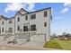 Modern townhome featuring three garages, second story balconies, and sleek white siding for stylish curb appeal at 4231 Barrel Ln, Westfield, IN 46062