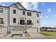 Modern townhome featuring three garages, second story balconies, and sleek white siding for stylish curb appeal at 4231 Barrel Ln, Westfield, IN 46062