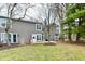 Backyard view of two story home with a wood deck, red grill, and grassy yard at 7854 Harbour Isle, Indianapolis, IN 46240