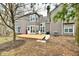 Backyard view of two story home with a wood deck, red grill, and bare spots in the yard at 7854 Harbour Isle, Indianapolis, IN 46240
