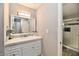 Bathroom featuring a vanity and a glass shower with white tile and decorative accent at 7854 Harbour Isle, Indianapolis, IN 46240