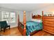 Comfortable bedroom with hardwood floors, natural light, and wooden furniture at 7854 Harbour Isle, Indianapolis, IN 46240
