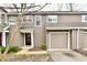 Charming townhome featuring a one-car garage, neat landscaping, and neutral toned siding at 7854 Harbour Isle, Indianapolis, IN 46240
