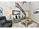 Inviting living room with high ceilings, modern decor, and a staircase at 7854 Harbour Isle, Indianapolis, IN 46240