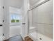 Modern bathroom with a walk-in shower and built-in seat at 9275 Loyola Way, Plainfield, IN 46168