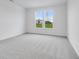 Well-lit bedroom with grey carpet and large windows at 9275 Loyola Way, Plainfield, IN 46168