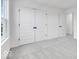 Bedroom with grey carpet, double doors, and access to another room at 9275 Loyola Way, Plainfield, IN 46168