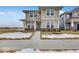 Two-story house with light beige siding, green door and landscaping at 9275 Loyola Way, Plainfield, IN 46168