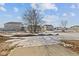 View of backyard showing other homes and snow on the ground at 10133 Redwood Peak Ln, Indianapolis, IN 46259