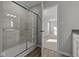 Modern bathroom featuring a tiled shower with glass doors and neutral walls at 10133 Redwood Peak Ln, Indianapolis, IN 46259