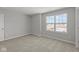 This cozy bedroom is brightly lit and features a large window with outdoor views at 10133 Redwood Peak Ln, Indianapolis, IN 46259