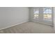 This bedroom features neutral paint, soft carpeting and two bright, sunny windows at 10133 Redwood Peak Ln, Indianapolis, IN 46259