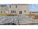Rear exterior of home with gray siding, patio, and snowy yard at 10133 Redwood Peak Ln, Indianapolis, IN 46259