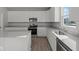 Modern kitchen featuring white cabinets, stainless steel appliances, and a center island at 10133 Redwood Peak Ln, Indianapolis, IN 46259