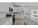 Well-lit kitchen with stainless steel appliances, a central island, and ample counter space at 10133 Redwood Peak Ln, Indianapolis, IN 46259