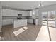 Bright, open kitchen with stainless steel appliances, an island, and sliding door access to the yard at 10133 Redwood Peak Ln, Indianapolis, IN 46259