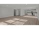 Spacious living room flows into an open kitchen with modern white cabinets and hardwood floors at 10133 Redwood Peak Ln, Indianapolis, IN 46259