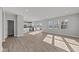Open-concept living space with a view of the kitchen, patio access, and natural light at 10133 Redwood Peak Ln, Indianapolis, IN 46259