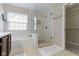 Bathroom with soaking tub, glass enclosed shower, and tile flooring at 10476 Prairie Fox Dr, Fishers, IN 46037