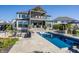 Luxurious backyard featuring a stunning pool, outdoor kitchen, and covered patio for entertaining at 10937 Pete Dye Rdg, Zionsville, IN 46077