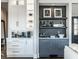 Stylish bar area features white and gray cabinetry, open shelving, and modern fixtures at 10937 Pete Dye Rdg, Zionsville, IN 46077