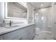 Bright bathroom with a modern vanity, illuminated mirror, and a glass shower at 10937 Pete Dye Rdg, Zionsville, IN 46077