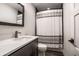 Elegant bathroom with marble countertop, modern vanity, and stylish shower with a decorative shower curtain at 10937 Pete Dye Rdg, Zionsville, IN 46077