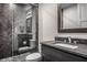 Modern bathroom featuring a glass-enclosed shower with tile, vanity, sink and large mirror at 10937 Pete Dye Rdg, Zionsville, IN 46077