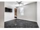 Bright bedroom featuring a ceiling fan, window, and mounted television for modern living and convenience at 10937 Pete Dye Rdg, Zionsville, IN 46077