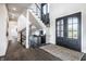 Inviting foyer with hardwood floors, modern staircase, and elegant decor, creating a sophisticated entrance at 10937 Pete Dye Rdg, Zionsville, IN 46077