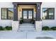 Welcoming entryway with a stylish double door, stone accents, and potted plants for added charm at 10937 Pete Dye Rdg, Zionsville, IN 46077