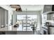Bright kitchen has large windows offering scenic views, a large island, and stainless steel appliances at 10937 Pete Dye Rdg, Zionsville, IN 46077