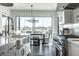 Bright kitchen featuring a large island and modern appliances, with an adjacent dining area at 10937 Pete Dye Rdg, Zionsville, IN 46077