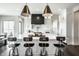 Bright kitchen features a large island with seating and modern lighting at 10937 Pete Dye Rdg, Zionsville, IN 46077