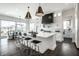 Bright kitchen features a large island with seating, modern lighting, and stainless steel appliances at 10937 Pete Dye Rdg, Zionsville, IN 46077