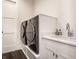 Well-equipped laundry room with modern washer and dryer, complemented by a sleek sink and storage at 10937 Pete Dye Rdg, Zionsville, IN 46077