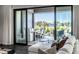Living area with large sliding doors opening to an outdoor patio, providing ample natural light and space at 10937 Pete Dye Rdg, Zionsville, IN 46077