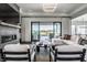 Bright living room with a modern fireplace, comfortable seating, and a view of the backyard pool and patio at 10937 Pete Dye Rdg, Zionsville, IN 46077