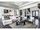 Open-concept living space with a cozy sectional, modern lighting, and seamless flow to the kitchen and stairs at 10937 Pete Dye Rdg, Zionsville, IN 46077