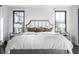 Main bedroom featuring a king bed, and natural light from flanking windows at 10937 Pete Dye Rdg, Zionsville, IN 46077