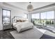 Bright main bedroom with large windows, a king bed, and natural light at 10937 Pete Dye Rdg, Zionsville, IN 46077